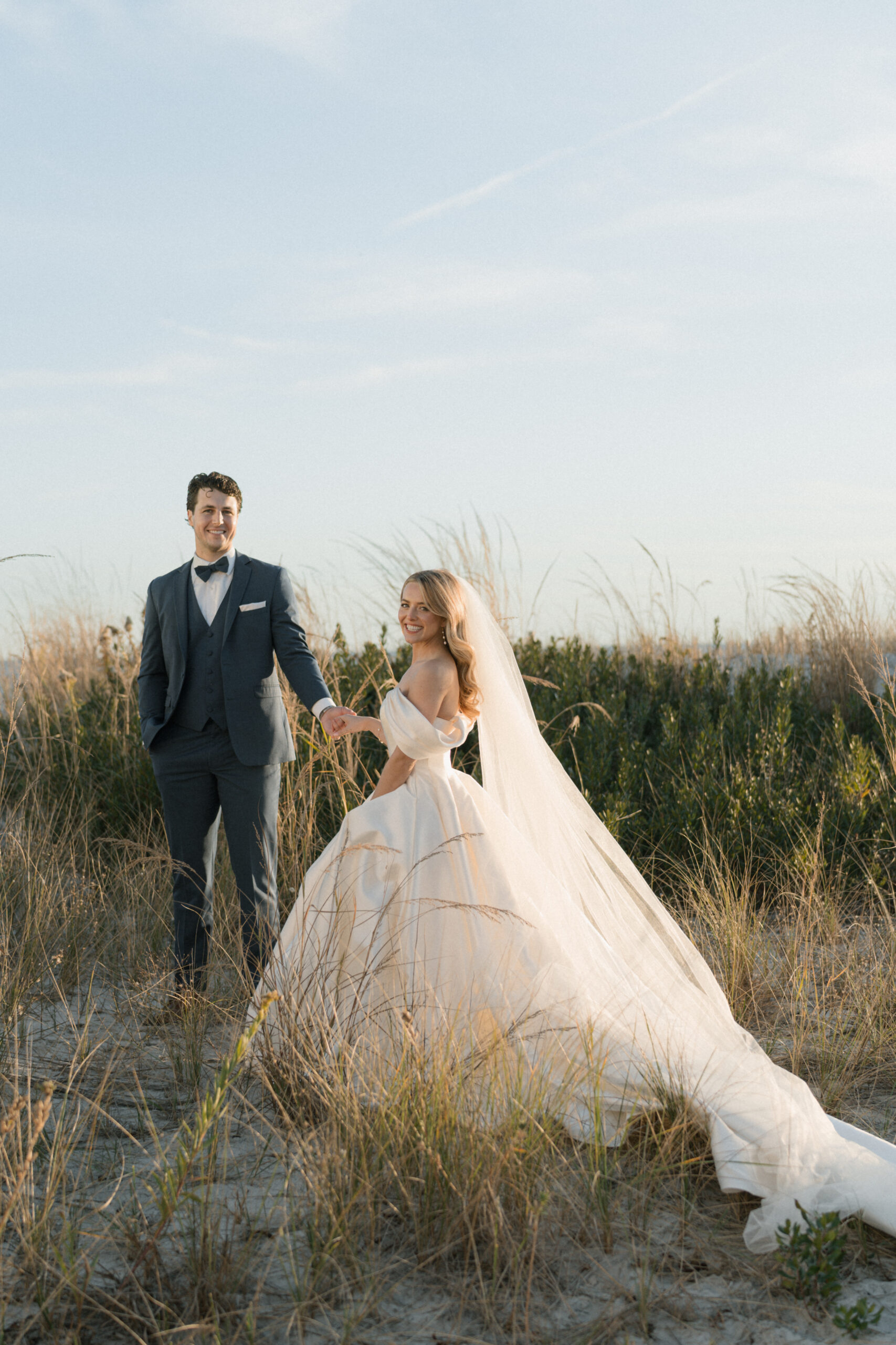 Bride and groom on Cape May dunes at sunset